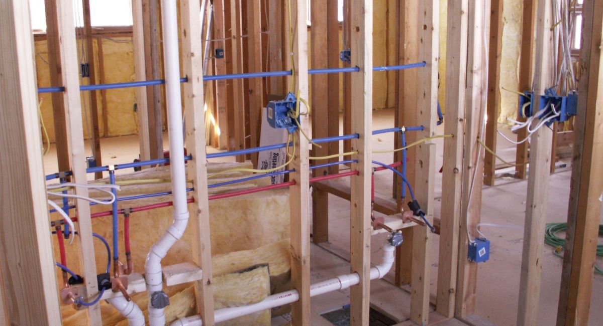 Framed plumbing systems inside a newly constructed home by plumbers in Fairfield, AL.