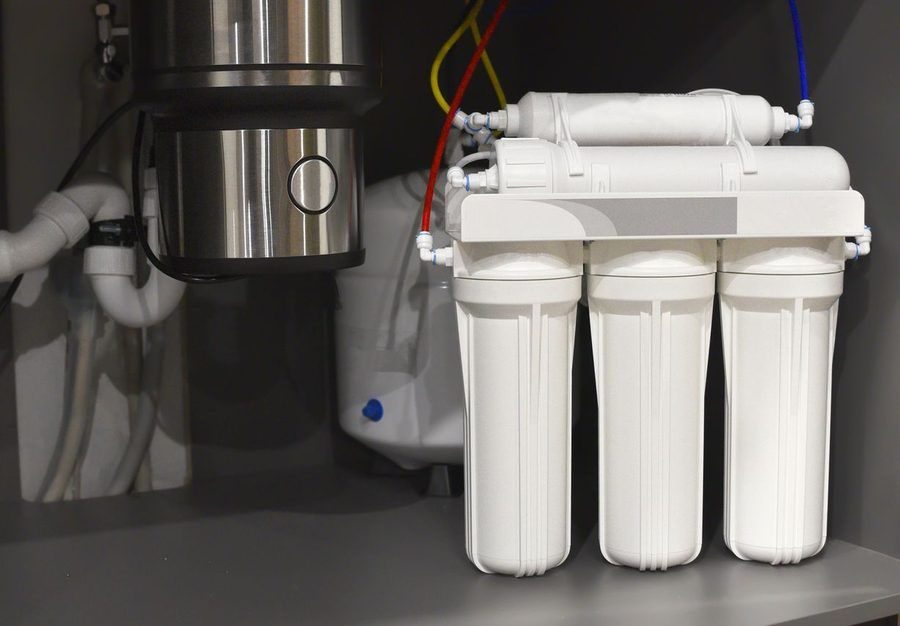 Water filtration system under a kitchen sink.