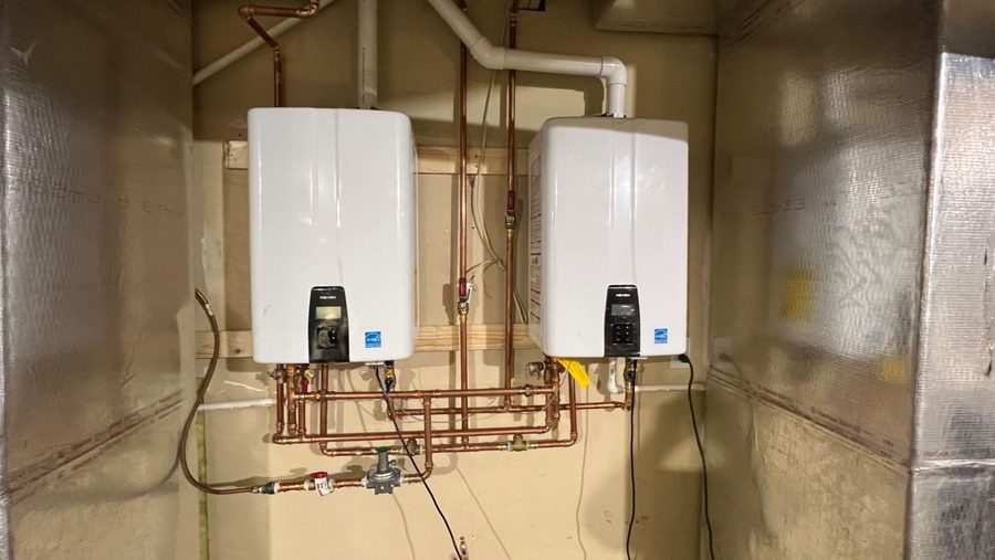 Two tankless water heaters installed in basement.