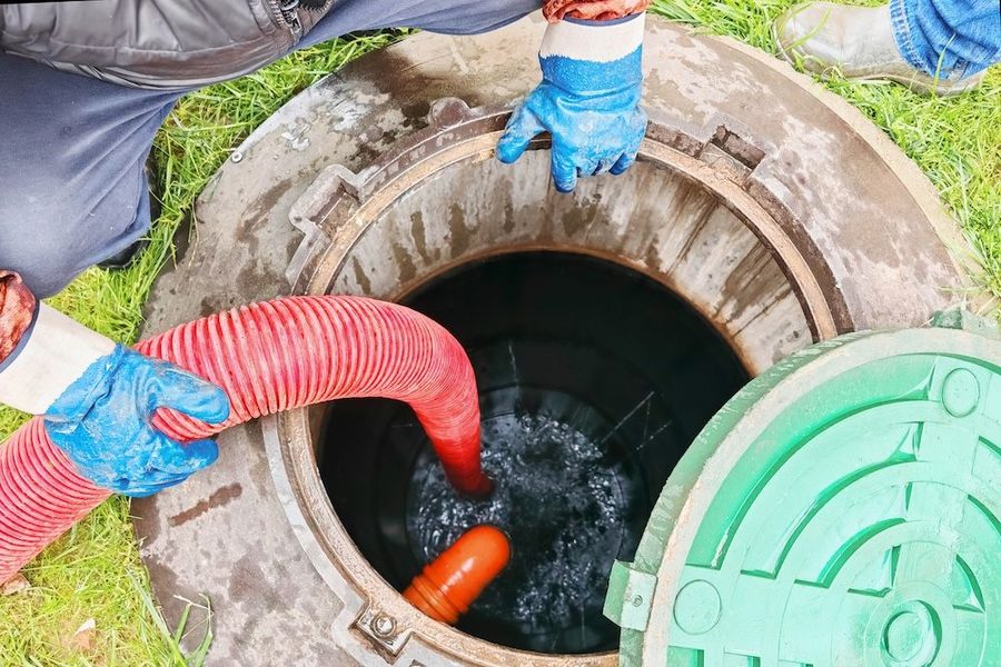 Plumbers repairing and inspecting a sewer